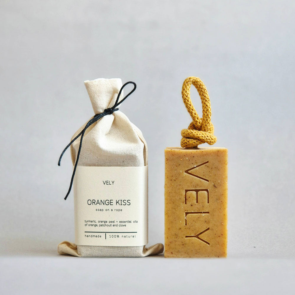 VELY Orange Kiss soap bar and packaging on a light gray background